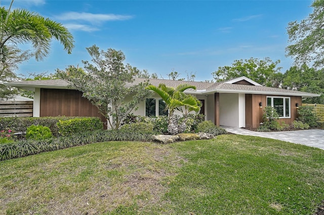 577 Corwood Dr, Sarasota, FL 34234 - view of front of property featuring a front yard, stucco siding, and fence