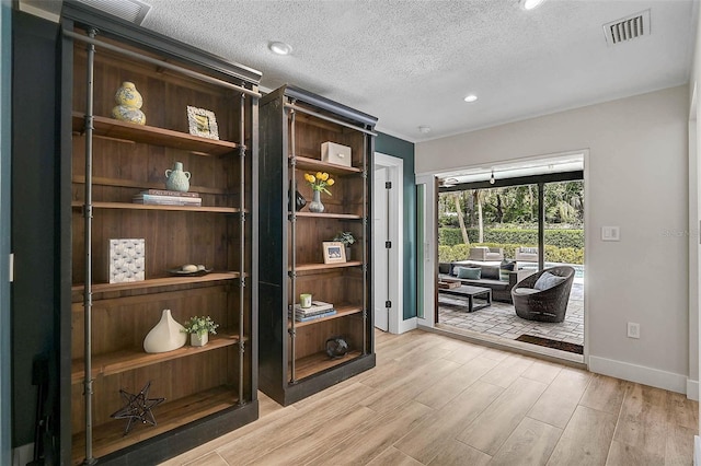 577 Corwood Dr, Sarasota, FL 34234 - interior space with a textured ceiling, visible vents, light wood finished floors, baseboards, and recessed lighting