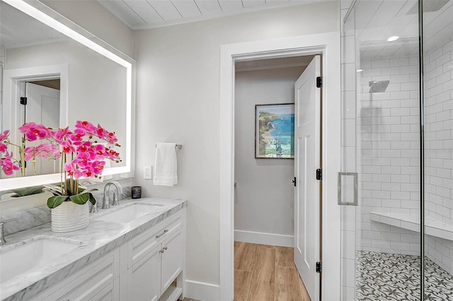 577 Corwood Dr, Sarasota, FL 34234 - bathroom with wood finished floors, a sink, double vanity, and a shower stall