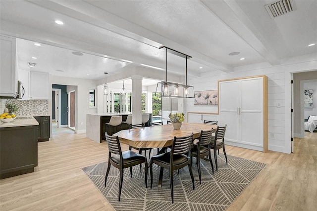 577 Corwood Dr, Sarasota, FL 34234 - dining room with baseboards, beam ceiling, light wood-style floors, and visible vents