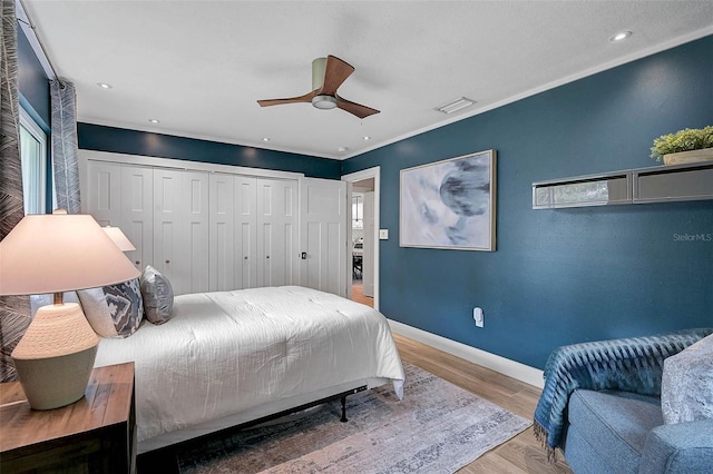 577 Corwood Dr, Sarasota, FL 34234 - bedroom featuring ornamental molding, baseboards, ceiling fan, visible vents, and wood finished floors