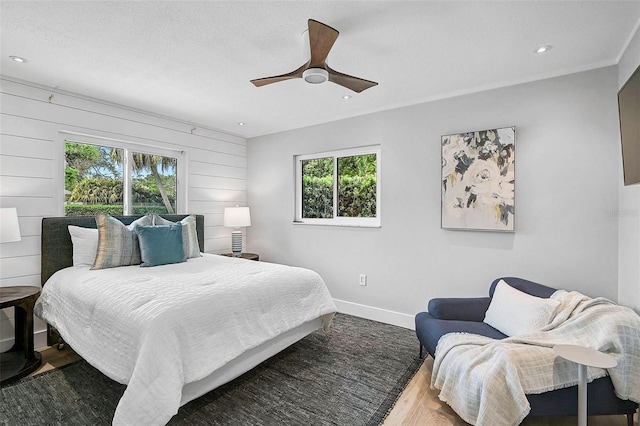 577 Corwood Dr, Sarasota, FL 34234 - bedroom with wood finished floors, a textured ceiling, baseboards, ceiling fan, and recessed lighting