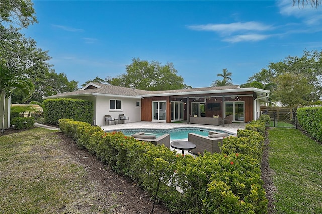 577 Corwood Dr, Sarasota, FL 34234 - rear view of house with outdoor lounge area, a fenced backyard, a patio, and an outdoor hot tub