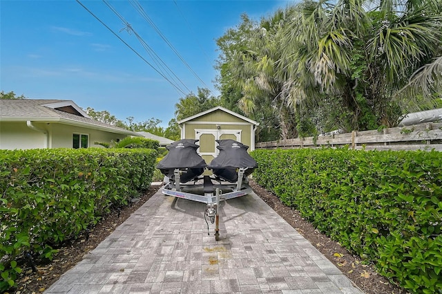 577 Corwood Dr, Sarasota, FL 34234 - view of patio / terrace featuring an outbuilding, fence, and a storage shed