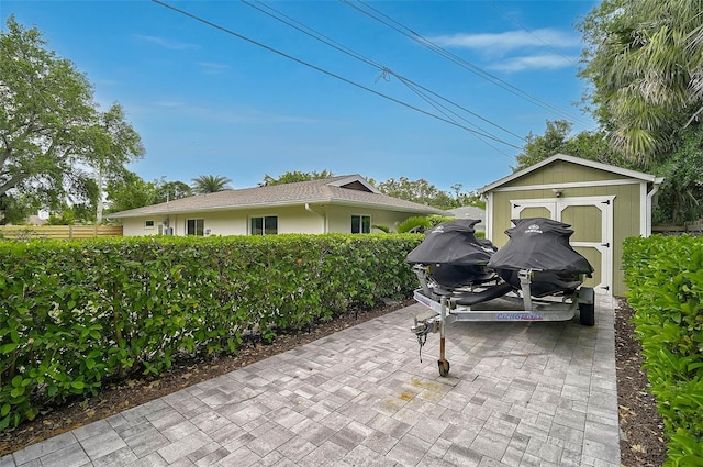 577 Corwood Dr, Sarasota, FL 34234 - view of patio with an outbuilding, a shed, and fence