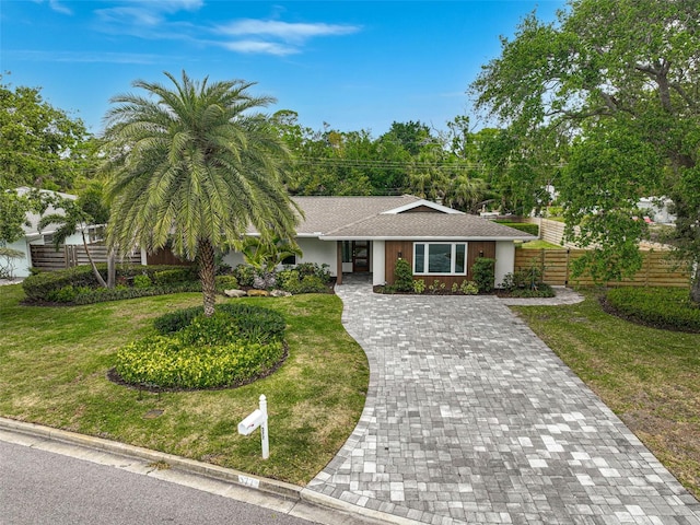 577 Corwood Dr, Sarasota, FL 34234 - ranch-style house with decorative driveway, stucco siding, fence, and a front lawn