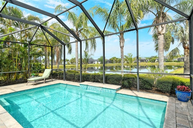 outdoor pool featuring a water view, a lanai, and a patio area
