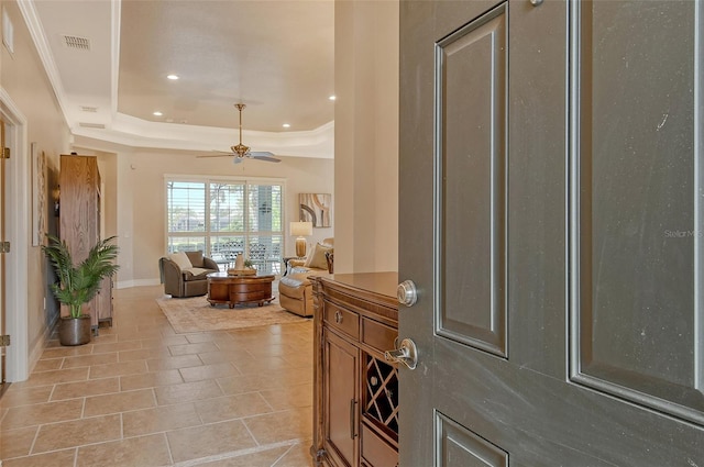 foyer with a raised ceiling, light tile patterned floors, visible vents, ceiling fan, and recessed lighting