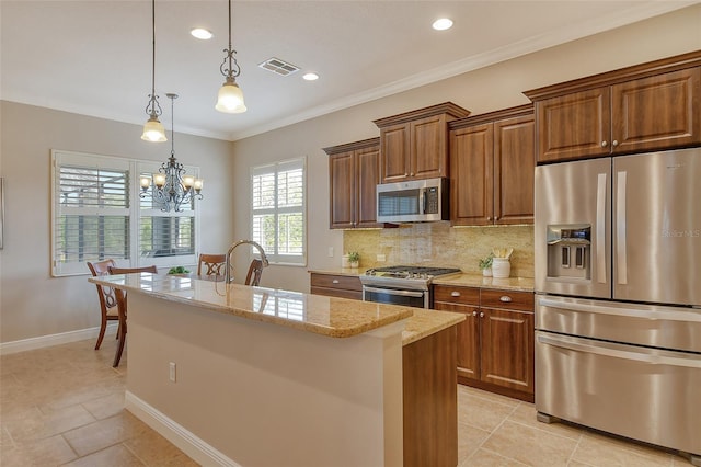 kitchen with backsplash, a center island with sink, light stone counters, visible vents, and appliances with stainless steel finishes