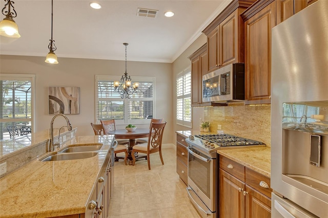 kitchen featuring decorative backsplash, visible vents, light stone countertops, stainless steel appliances, and a sink
