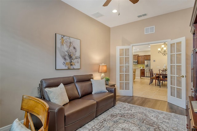 living area featuring visible vents, french doors, and wood finished floors
