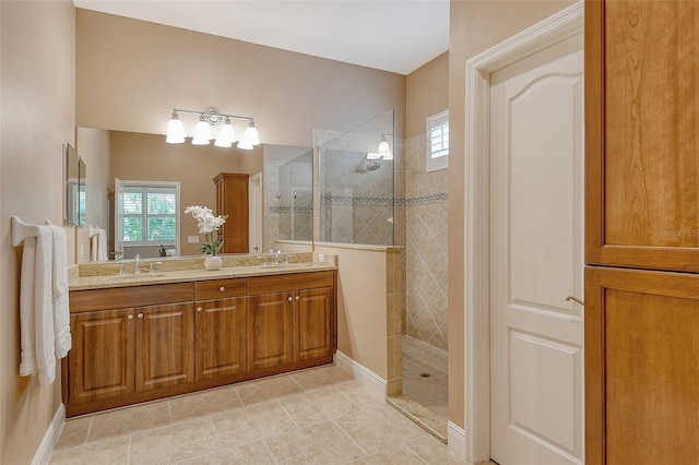 bathroom with a sink, tile patterned floors, double vanity, and walk in shower