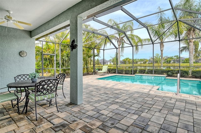 pool featuring a lanai, a patio, and a ceiling fan
