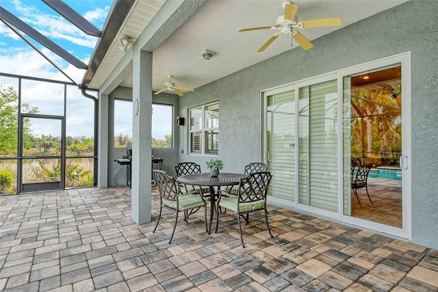 sunroom / solarium featuring a wealth of natural light and a ceiling fan