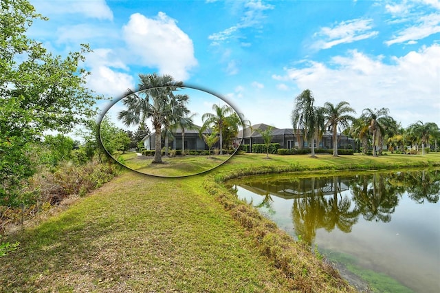 view of home's community featuring a water view and a yard