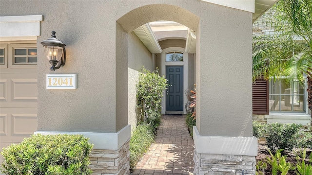 12041 Thornhill Ct, Lakewood Ranch, FL 34202 - property entrance with a garage and stucco siding