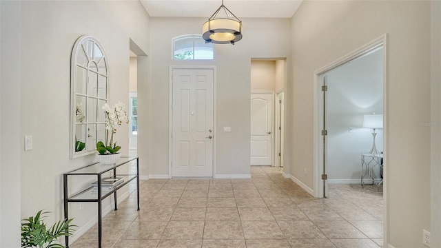 12041 Thornhill Ct, Lakewood Ranch, FL 34202 - entrance foyer featuring baseboards, a notable chandelier, and a high ceiling