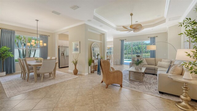 12041 Thornhill Ct, Lakewood Ranch, FL 34202 - living area featuring ornamental molding, ceiling fan with notable chandelier, visible vents, and a healthy amount of sunlight