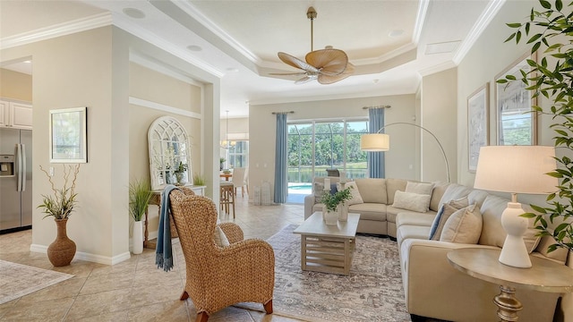 12041 Thornhill Ct, Lakewood Ranch, FL 34202 - living room featuring a raised ceiling, ceiling fan, baseboards, and ornamental molding