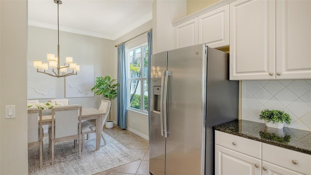 12041 Thornhill Ct, Lakewood Ranch, FL 34202 - kitchen with stainless steel fridge with ice dispenser, an inviting chandelier, tasteful backsplash, ornamental molding, and white cabinets