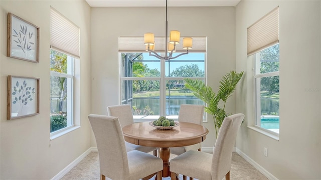12041 Thornhill Ct, Lakewood Ranch, FL 34202 - dining area with an inviting chandelier and a healthy amount of sunlight