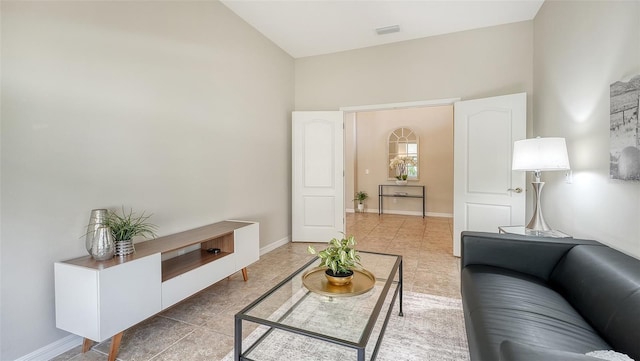 12041 Thornhill Ct, Lakewood Ranch, FL 34202 - tiled living area featuring high vaulted ceiling and baseboards