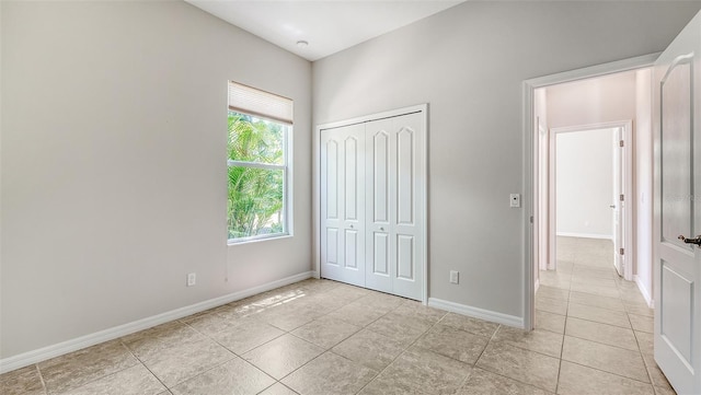 12041 Thornhill Ct, Lakewood Ranch, FL 34202 - unfurnished bedroom featuring light tile patterned floors, baseboards, and a closet