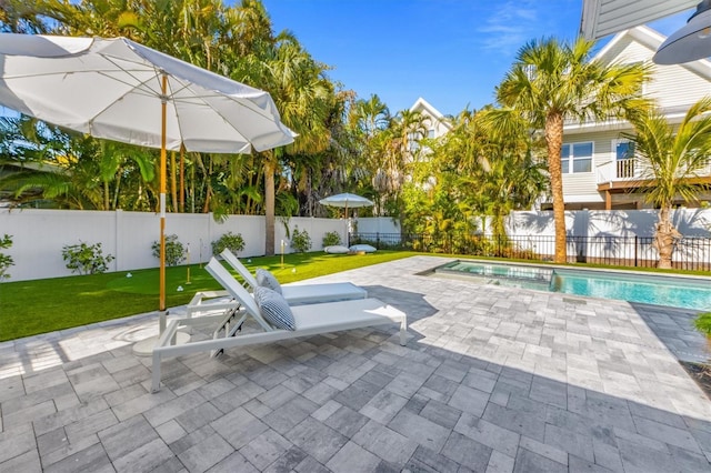 view of swimming pool with a patio, a fenced backyard, a lawn, and a fenced in pool
