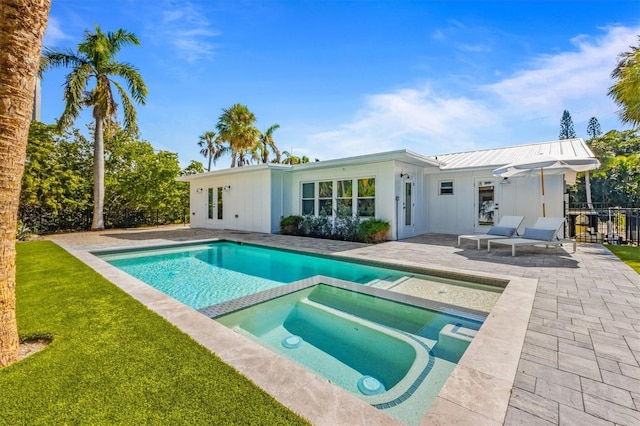 view of swimming pool featuring a yard, a patio, and a pool with connected hot tub