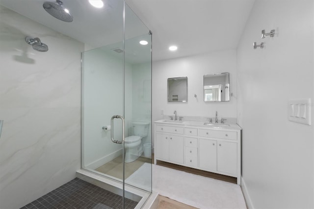 bathroom with double vanity, a sink, tile patterned flooring, and a stall shower