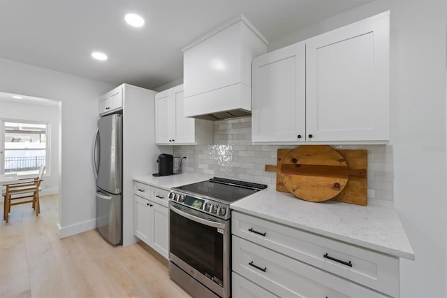 kitchen featuring backsplash, appliances with stainless steel finishes, light stone countertops, recessed lighting, and white cabinetry