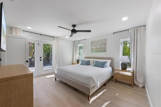 bedroom with recessed lighting, light wood-style flooring, multiple windows, and access to exterior