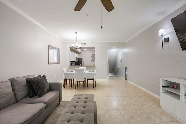 living room featuring crown molding, ceiling fan with notable chandelier, baseboards, and built in features