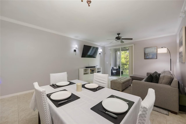 dining room featuring ceiling fan, ornamental molding, baseboards, and light tile patterned floors