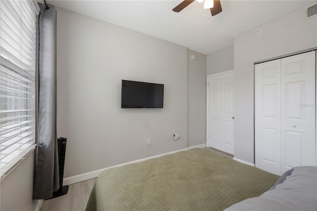 unfurnished bedroom featuring multiple windows, a closet, and baseboards