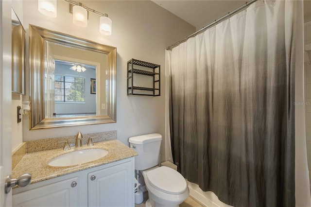 full bath featuring toilet, curtained shower, and vanity