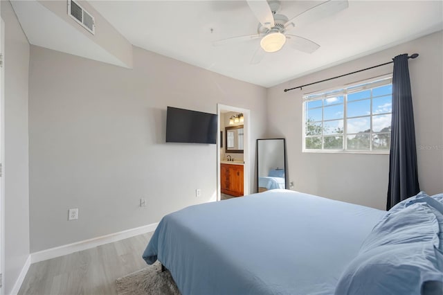 5691 Bentgrass Dr Unit 211, Sarasota, FL 34235 - bedroom featuring light wood-style floors, ceiling fan, and connected bathroom