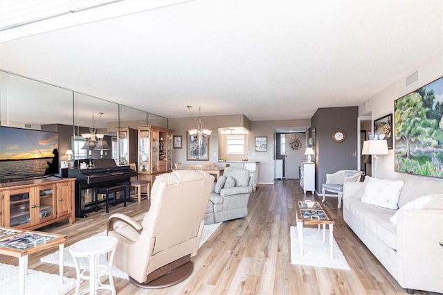 3620 Ironwood Cir Unit 606, Bradenton, FL 34209 - living area featuring light wood-style flooring, a chandelier, and visible vents