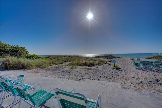 view of patio / terrace featuring a beach view and a water view