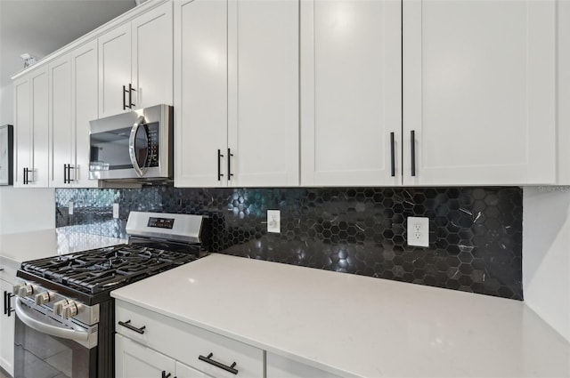 15104 Blue Bay Ter, Lakewood Ranch, FL 34211 - kitchen featuring stainless steel appliances, decorative backsplash, and white cabinetry