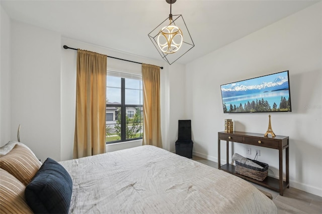 15104 Blue Bay Ter, Lakewood Ranch, FL 34211 - bedroom featuring baseboards and a chandelier