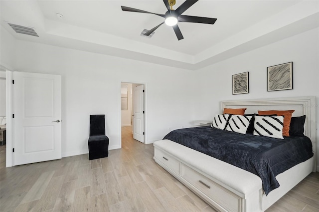15104 Blue Bay Ter, Lakewood Ranch, FL 34211 - bedroom with a raised ceiling, light wood-type flooring, baseboards, and ceiling fan