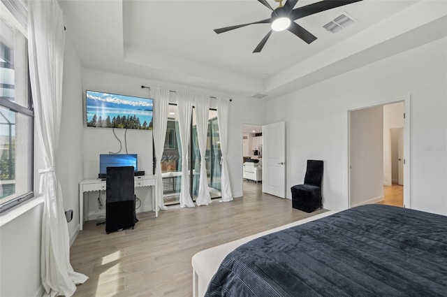 15104 Blue Bay Ter, Lakewood Ranch, FL 34211 - bedroom with a raised ceiling, light wood finished floors, an office area, and ceiling fan
