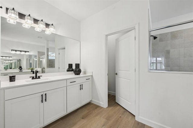 15104 Blue Bay Ter, Lakewood Ranch, FL 34211 - full bath featuring wood finished floors, vanity, a tile shower, and baseboards