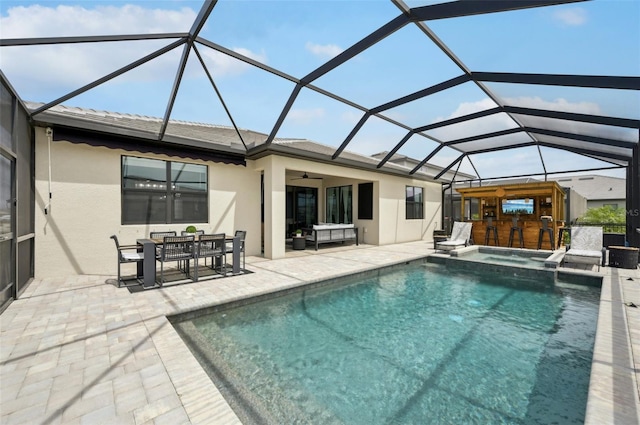 15104 Blue Bay Ter, Lakewood Ranch, FL 34211 - back of house featuring a patio, stucco siding, a ceiling fan, a lanai, and a pool with connected hot tub