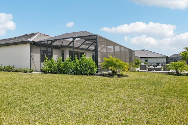 15104 Blue Bay Ter, Lakewood Ranch, FL 34211 - back of property featuring a lawn, stucco siding, a lanai, and central AC