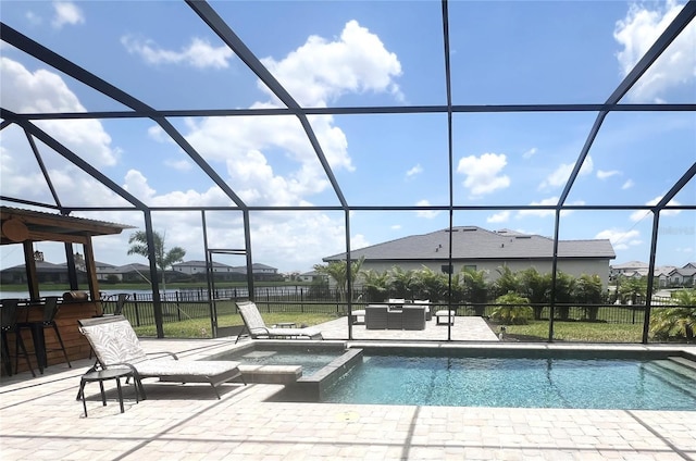 15104 Blue Bay Ter, Lakewood Ranch, FL 34211 - view of swimming pool featuring a patio area, a lanai, a pool with connected hot tub, and a residential view