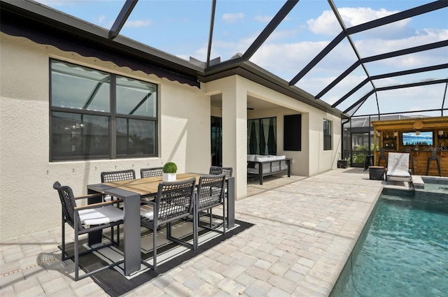 15104 Blue Bay Ter, Lakewood Ranch, FL 34211 - view of patio with a lanai, outdoor dining space, and a pool with connected hot tub