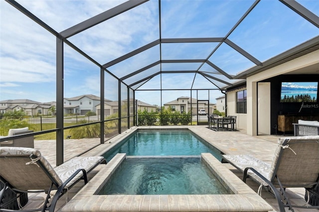 15104 Blue Bay Ter, Lakewood Ranch, FL 34211 - view of swimming pool featuring a patio, a pool with connected hot tub, a residential view, and glass enclosure
