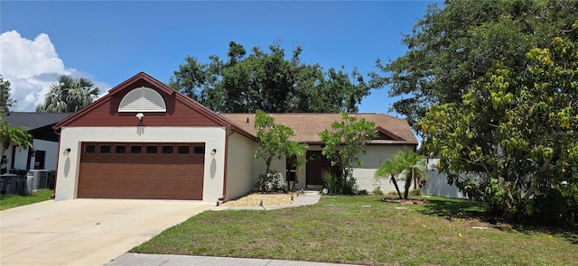 2385 Tall Oak Ct, Sarasota, FL 34232 - ranch-style home with an attached garage, central air condition unit, a front yard, driveway, and stucco siding